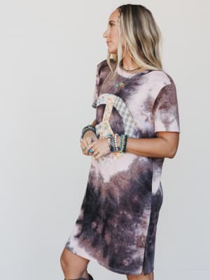 Woman wearing a tie-dye dress with a plain background