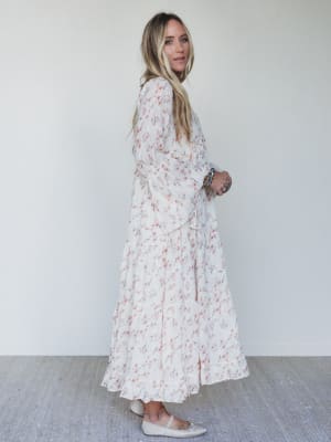 Woman wearing a floral dress against a white background