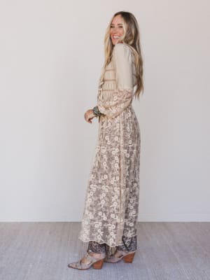 Woman wearing a floral dress with a plain background
